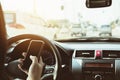 Close up of a lady driving car dangerously while using mobile phone