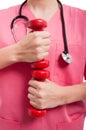 Close-up of lady wearing scrubs training with weights Royalty Free Stock Photo