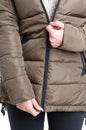 Close-up of lady zipping winter jacket