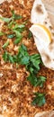 Close up of a lahmacun roll with tomato, parsley and lemon Royalty Free Stock Photo