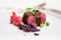 Close up of lamb chops with pea and purple potatoes