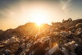 close-up of a landfill's towering pile of waste, with the sun shining down on it