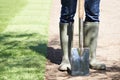 Close Up Of Landscape Gardener Laying Turf For New Lawn