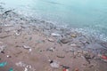 Landscape sea coast after storm , sand beach with plastic garbage pollution