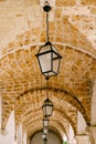 Close-up of lanterns on an arched brick ceiling. Royalty Free Stock Photo