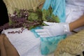 White gloves and purple flowers