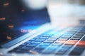 Close up of laptop with abstract binary code on blurry background. Cyber attack and hacking concept. Royalty Free Stock Photo