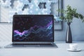 Close up of laptop with abstract glowing candlestick forex chart with index and grid on modern workplace backdrop with coffee cup