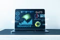 Close up of laptop with business chart at office workpace. Analytics, financial report and money concept. 3D Rendering