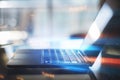 Close up of laptop computer with abstract binary code on blurry background. Cyber attack and hacking concept. Royalty Free Stock Photo