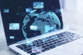 Close up of laptop computer with abstract globe, forex charts and graphs on blurry background. Global trading and market concept. Royalty Free Stock Photo