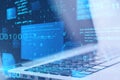Close up of laptop computer at desktop with abstract glowing blue coding background. Binary code, technology, data and internet Royalty Free Stock Photo
