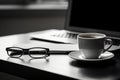 Close up laptop computer eyeglasses glasses with cup of tea coffee latte standing on table office desk workplace Royalty Free Stock Photo