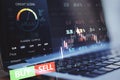 Close up of laptop computer with forex chart and sell, buy buttons on blurry background. Stock exchange, cryptocurrency and global