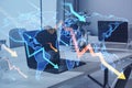 Close up of laptop on coworking office desk with downward falling arrows and map on background. Stock or financial market