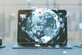 Close up of laptop with creative globe with telecommunication picture icons on blurry office workplace backdrop. Business, video
