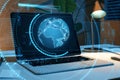 Close up of laptop with creative glowing blue map or globe hologram on blurry workplace background with lamp and other items.