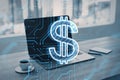 Close up of laptop on desktop with coffee cup, notepad, glowing dollar circuit sign on blurry background. Digital money Royalty Free Stock Photo