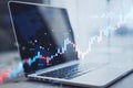 Close up of laptop with glowing candlestick forex chart on blurry background. Trade, finance and growing market concept. Double Royalty Free Stock Photo