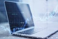 Close up of laptop with glowing candlestick forex chart with index on background. Trade, stock and finance concept. Double Royalty Free Stock Photo