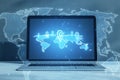 Close up of laptop with glowing map with location pins on background. GPS and navigation concept. 3D Rendering