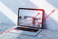 Close up of laptop with growing red business chart arrow on blurry background with sunlight. Finance, profit and increase concept Royalty Free Stock Photo