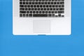 Close Up of Laptop Keyboard on Blue Background