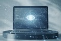 Close up of laptop on pedestal with cyber spy technology hologram, virtual eye of internet control surveillance and digital