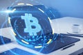 Close up of laptop with round bitcoin interface on blurry desktop background. Cryptocurrency and finance concept. Royalty Free Stock Photo