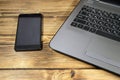 Close-up of laptop and smart phone on wooden desk Royalty Free Stock Photo