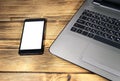 Close-up of laptop and smart phone on wooden desk Royalty Free Stock Photo