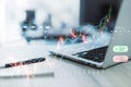 Close up of laptop and supplies on desk creative candlestick trading graph on blurry background. Selling and buying stocks, market Royalty Free Stock Photo