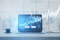 Close up of laptop at workplace with glowing blue sell and buy buttons, map and candlestick forex chart on blurry window city view Royalty Free Stock Photo