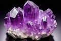close up of a large amethyst crystal cluster on black background