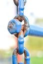 Close-up of large corroided domestic chain. Rusty blue painted metal chain Royalty Free Stock Photo