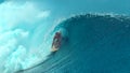 CLOSE UP: Large emerald ocean wave splashes over the cheerful extreme surfer. Royalty Free Stock Photo