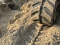 A close-up of large excavator tracks in the dirt on a construction site Royalty Free Stock Photo