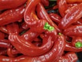 Close up of large glossy organic red chillies