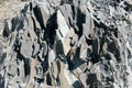 Close-up a large splitted into small pieces layered stone block of mountain slate.