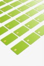 Close-up of a large group of green credit cards on a white background.