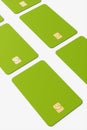 Close-up of a large group of green credit cards on a white background.