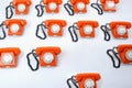 Close up of a large group of orange rotary telephones Royalty Free Stock Photo