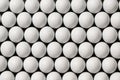 Close up of a large group of white golf balls arranged in neat rows on a dark background surface Royalty Free Stock Photo