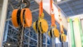 Close-up of large hanging industrial hooks with chains.