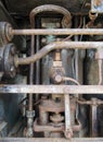 Close up of a large old abandoned marine diesel engine showing rusting pipes and cylinders and bolts Royalty Free Stock Photo