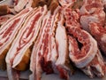 Close-up of large pieces of lard / bacon and pork meat at a market / grocery fair counter Royalty Free Stock Photo