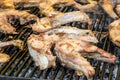 Close up of large portion of grilled fish on a large black pan at a street food festival, ready to eat healthy seafood, beautiful