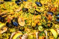 Close up of large portion of traditional Spanish paella dish freshly being cooked with seafood and pasta in a  frying pan at a str Royalty Free Stock Photo