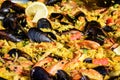 Close up of large portion of traditional Spanish paella dish freshly being cooked with seafood and rice in a frying pan at a stree Royalty Free Stock Photo