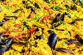 Close up of large portion of traditional Spanish paella dish freshly being cooked with seafood and rice in a frying pan at a stree Royalty Free Stock Photo